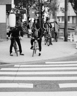 People riding bicycle on road