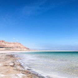 Scenic view of sea against clear blue sky