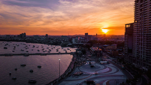 High angle view of street by buildings against sky during sunset