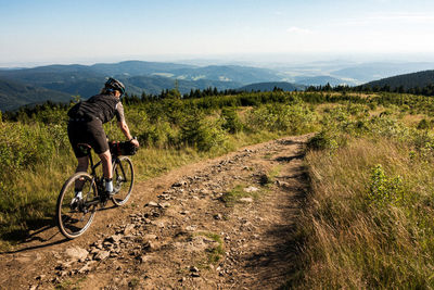 Bicycles riding bicycle on dirt road