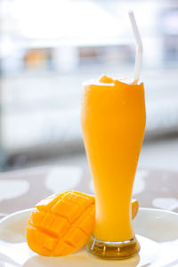 Close-up of orange juice on table