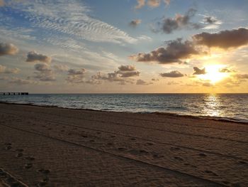 Scenic view of beach against sky during sunset