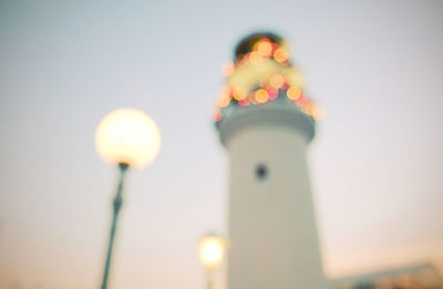 Low angle view of illuminated street light against building