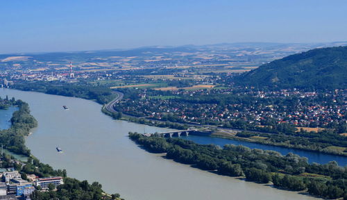 High angle view of cityscape and bay against sky