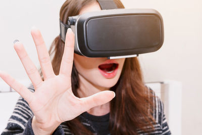 Young woman virtual reality while sitting at home