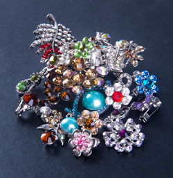 High angle view of diamond brooch on textured table