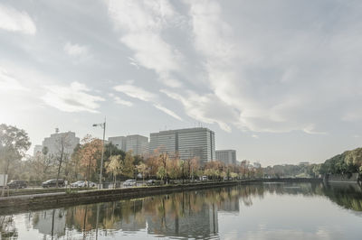 Reflection of buildings in lake against sky