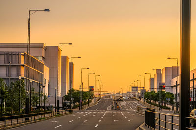 Buildings in city against sky during sunset