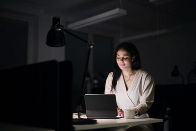 Woman working late in office