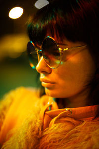 Close-up portrait of young woman wearing sunglasses