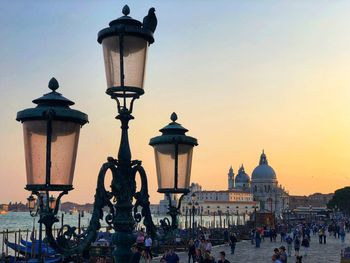 Street light in city at sunset