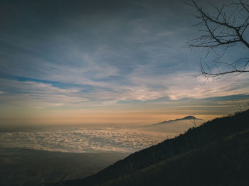 Scenic view of silhouette mountains against sky at sunset