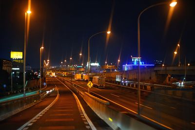 Illuminated cityscape against sky at night