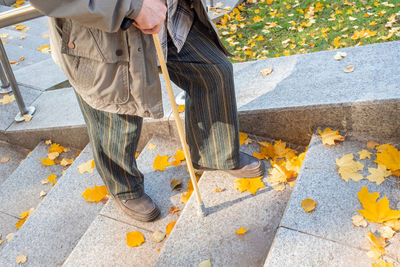 Low section of man standing on sidewalk