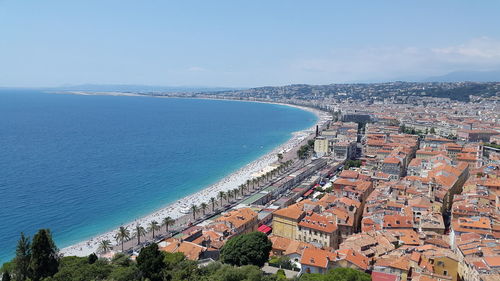 High angle view of townscape by sea against sky