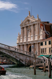 View of bridge over canal against buildings