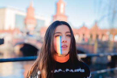 Portrait of beautiful young woman in city