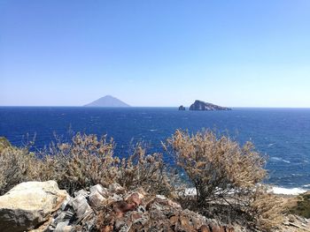 Scenic view of sea against clear blue sky