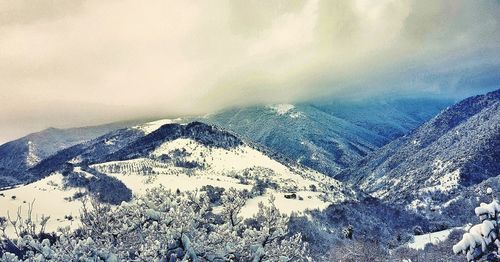 Scenic view of snowcapped mountains against sky