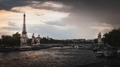 Boats in river with city in background