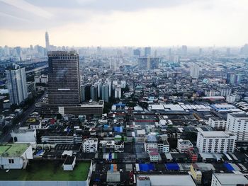 High angle view of modern buildings in city against sky