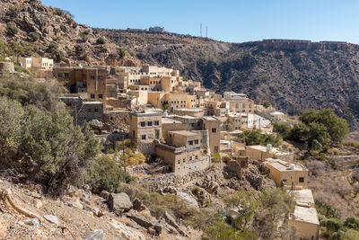 High angle view of houses and buildings against clear sky