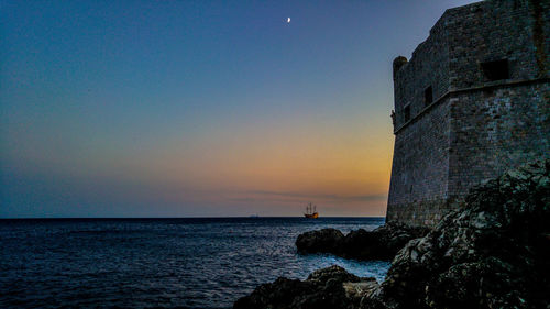 Scenic view of sea against clear sky during sunset