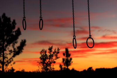 Close-up of swing against sky during sunset