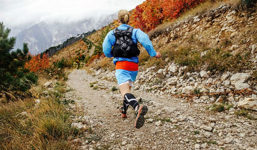 Rear view of woman running on land