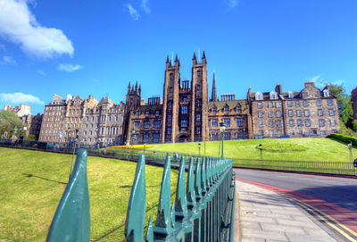 Buildings in city against blue sky