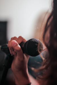 Close-up of woman holding microphone