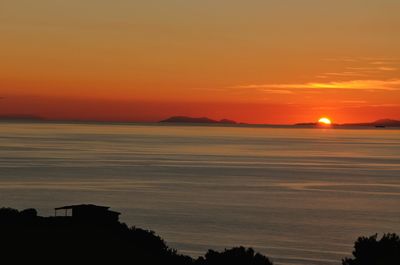 Scenic view of sea against romantic sky at sunset