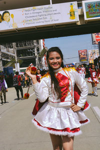 Portrait of young woman standing outdoors