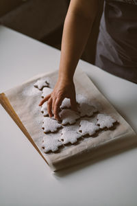 Christmas tree made of gingerbread cookies sprinkled with powdered sugar on wooden board