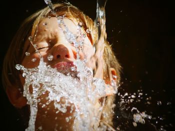 Close-up of boy swimming in water