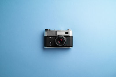 Close-up of camera on colored background