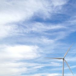 Low angle view of windmill against cloudy sky