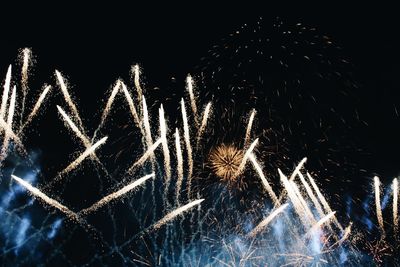 Low angle view of firework display at night