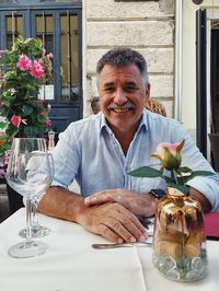 Portrait of senior man with food in restaurant