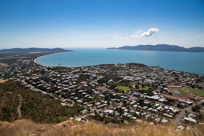 High angle view of townscape by sea against sky