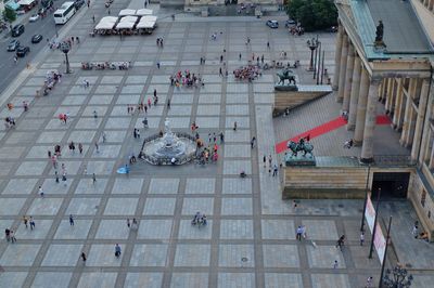 High angle view of people by historic building at town square
