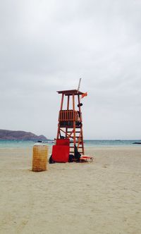 Lifeguard hut on beach against sky