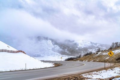 Scenic view of snow covered mountains against sky