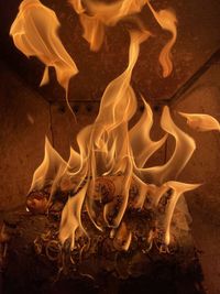 High angle view of lit candles on wooden floor