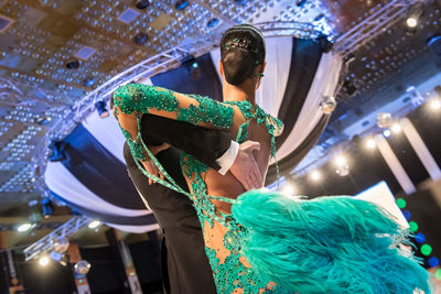 Low angle view of illuminated lighting equipment at night