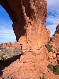 Low angle view of rock formations against blue sky