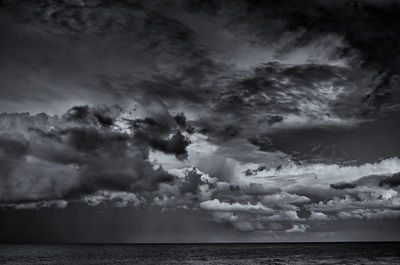 Scenic view of sea against storm clouds