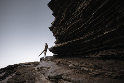 Rear view of man standing on rock