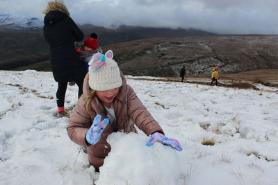 Rear view of women on snowy land