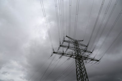 Low angle view of electricity pylon against sky